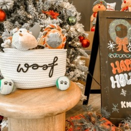 basket of dog toys in front of Christmas tree
