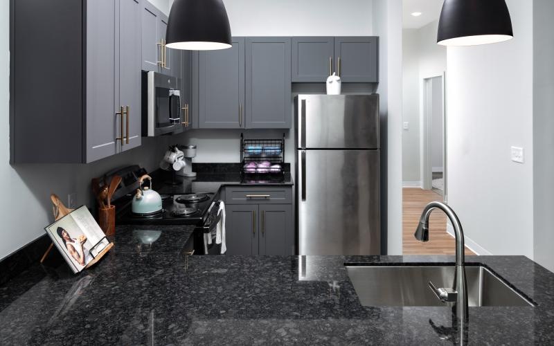 a kitchen with black cabinets